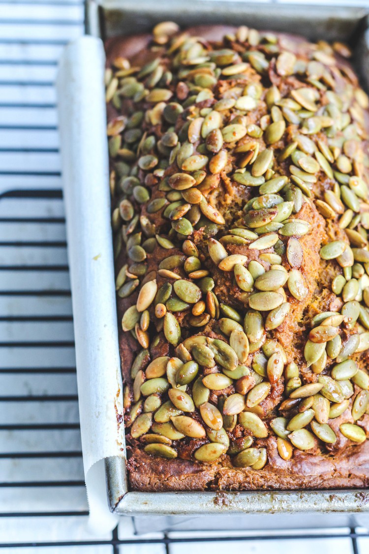 overhead shot of loaf of bread with pumpkin seeds