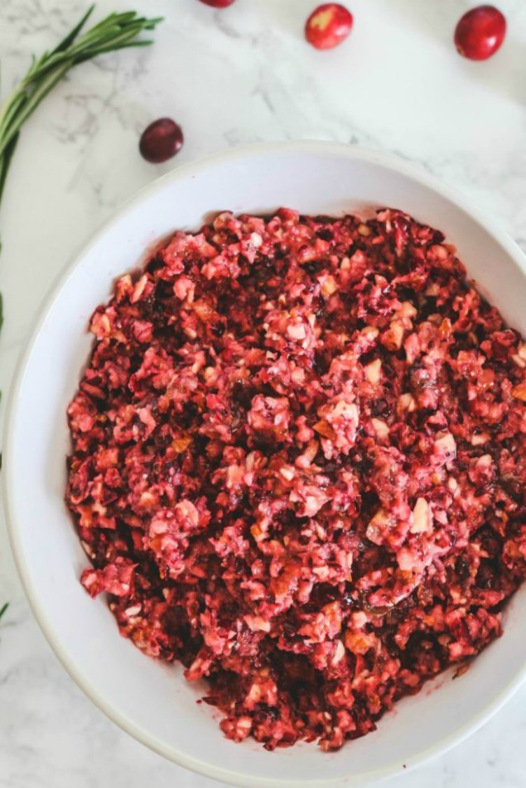overhead image of cranberry almond and tangerine relish in white bowl