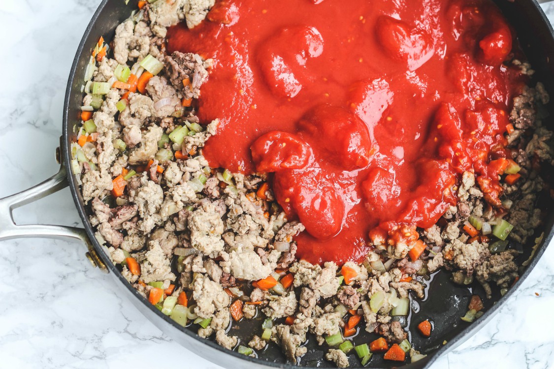 overhead image of ground turkey and tomato sauce in a skillet