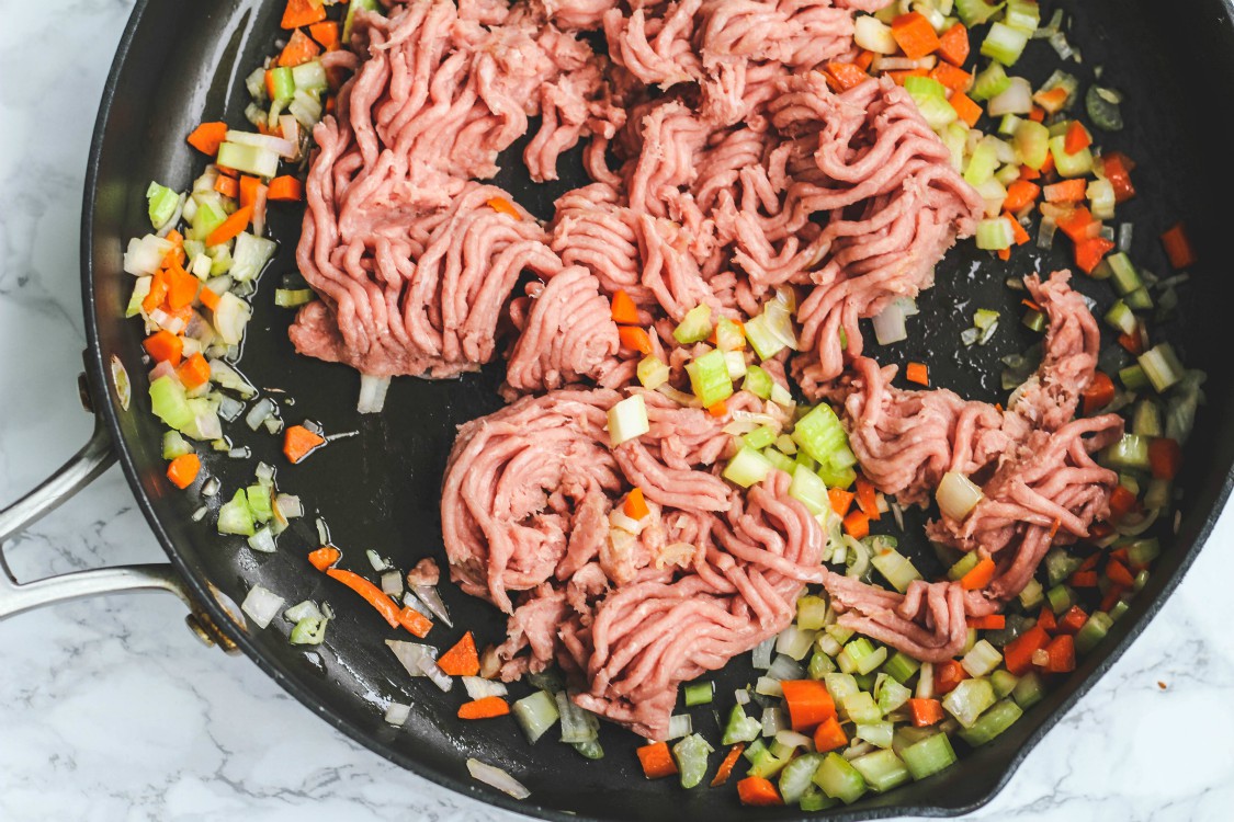 image of chopped vegetables and ground turkey in a large skillet