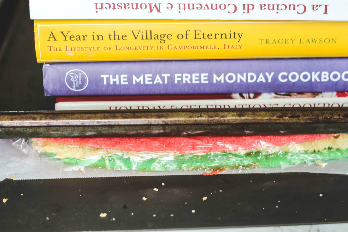 overhead image of cookbooks weighing down cake dough