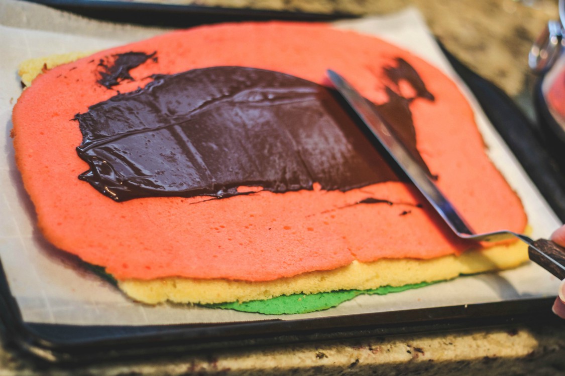 overhead image of chocoalate spread on red cookie dough