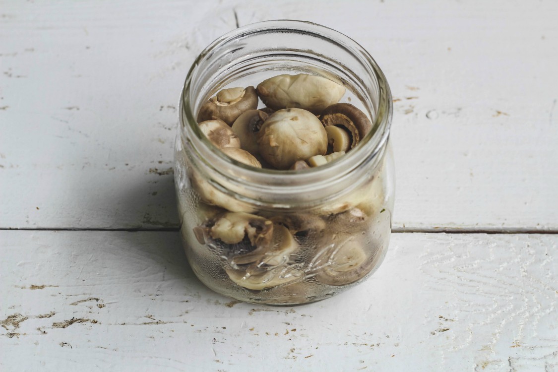 overhead image of mushrooms in a jar.