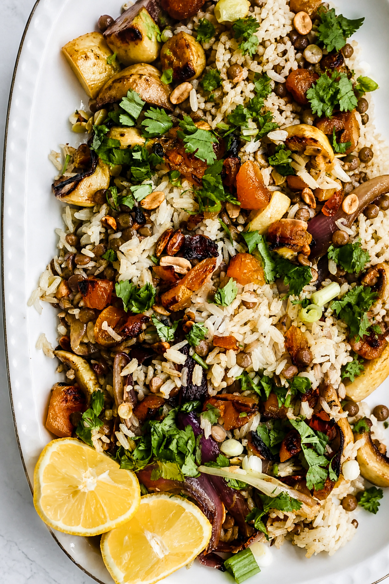 Vegan biryani salad in a large serving bowl with crispy fried shallots, cilantro, and colorful dried fruit