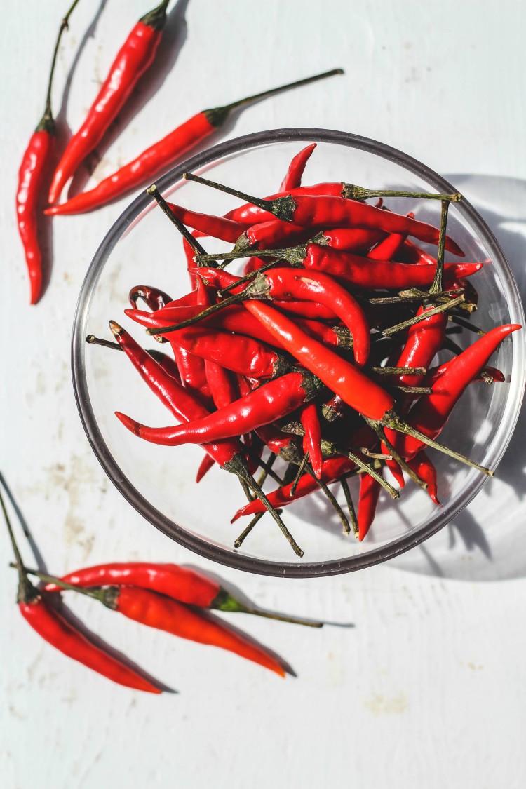 overhead image of Thai chili peppers in glass bowl