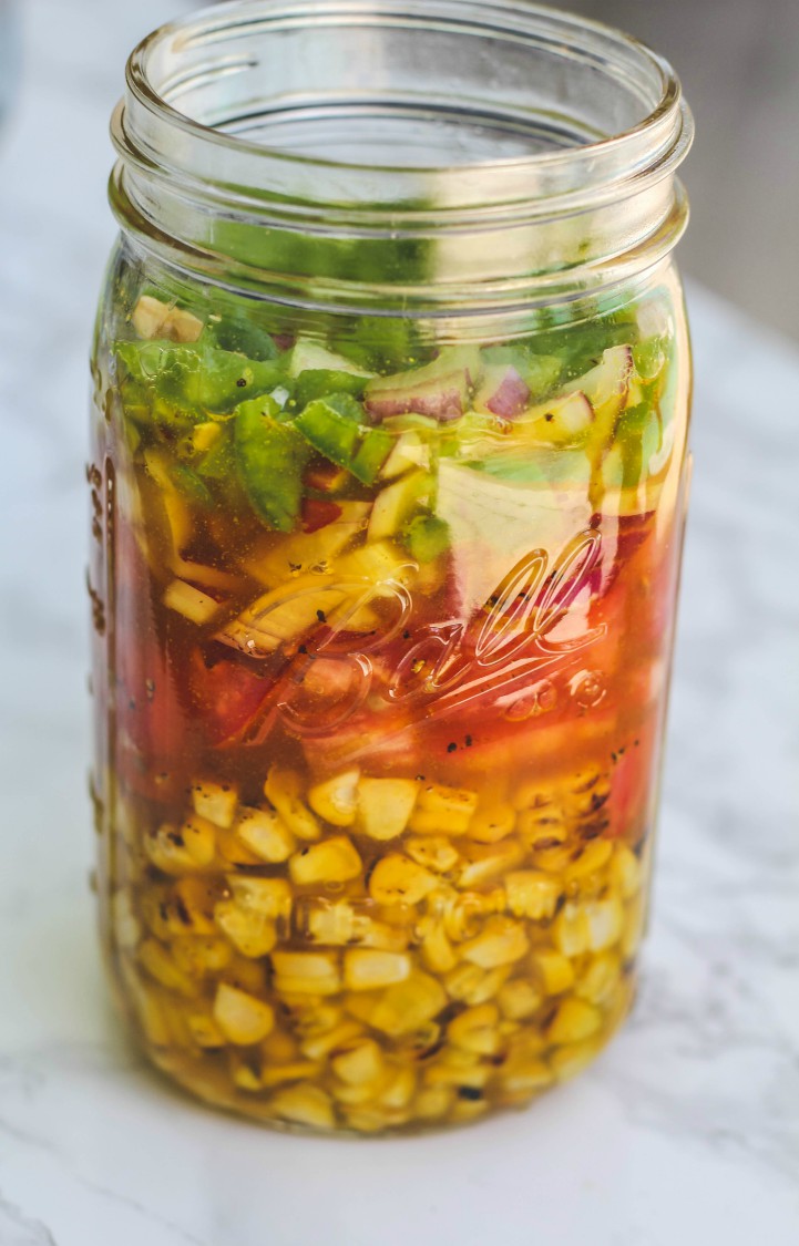 overhead image of sweet corn relish in a jar.