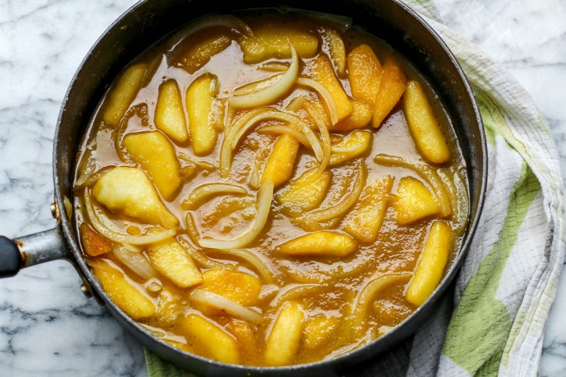 overhead image of apple and onion sauce in a large skillet