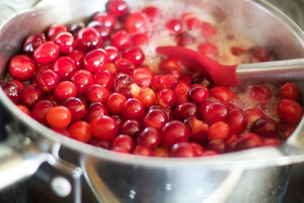 overhead image of making cranberry sauce in a pan