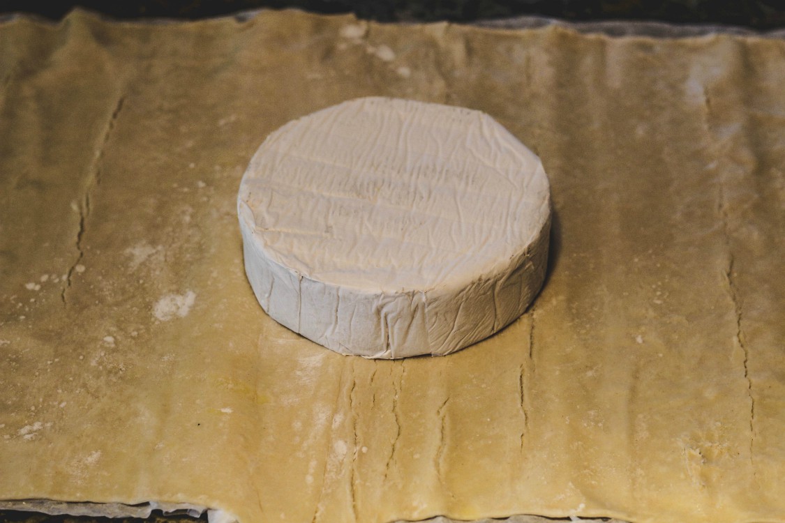 overhead image of brie on pastry sheet