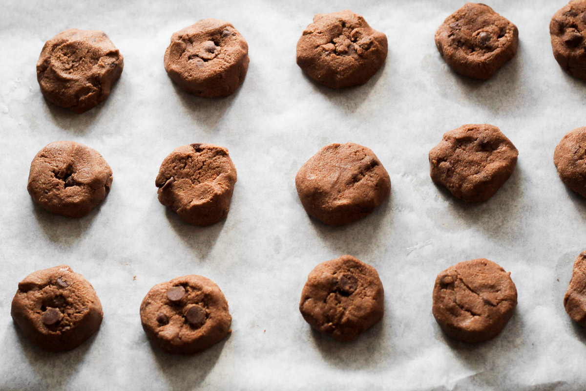 overhead image of chocolate cookie rounds on parchment paper
