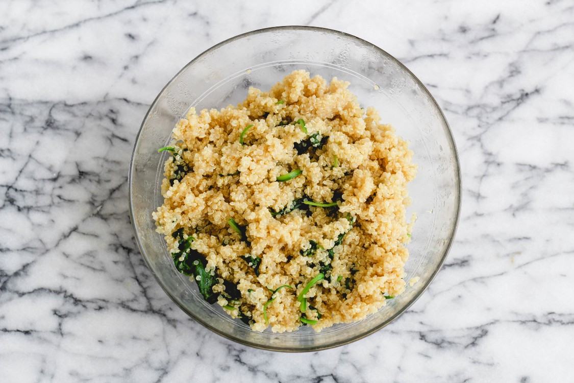 overhead image of quinoa with spinach in a glass bowl