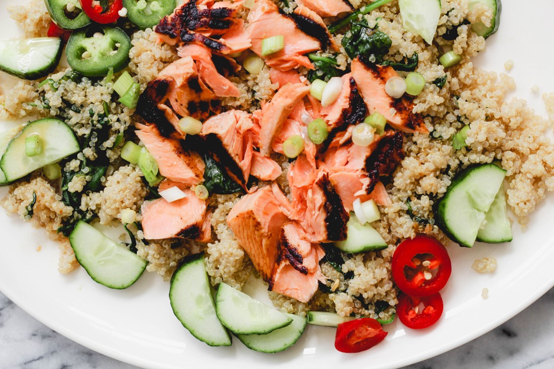 overhead image of salmon with quinoa and spinach 