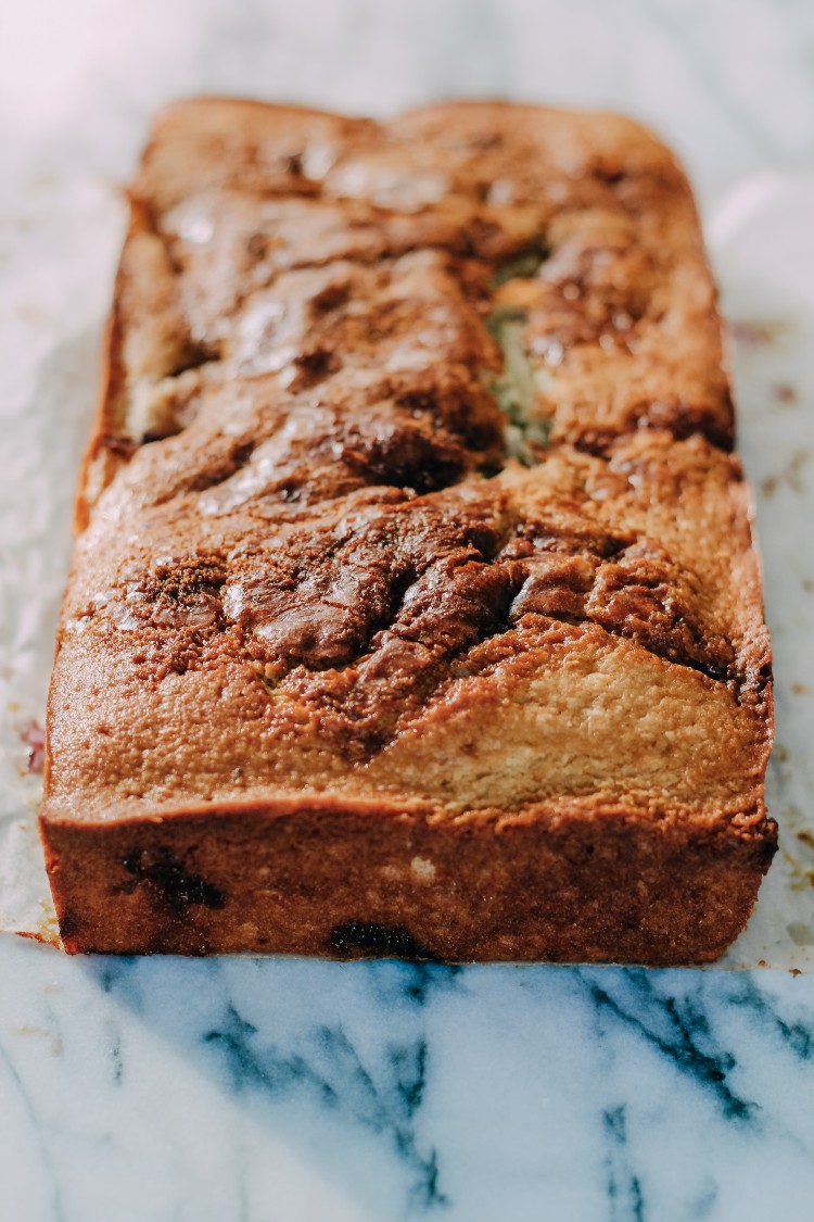 image of fresh plum quick bread on marble counter