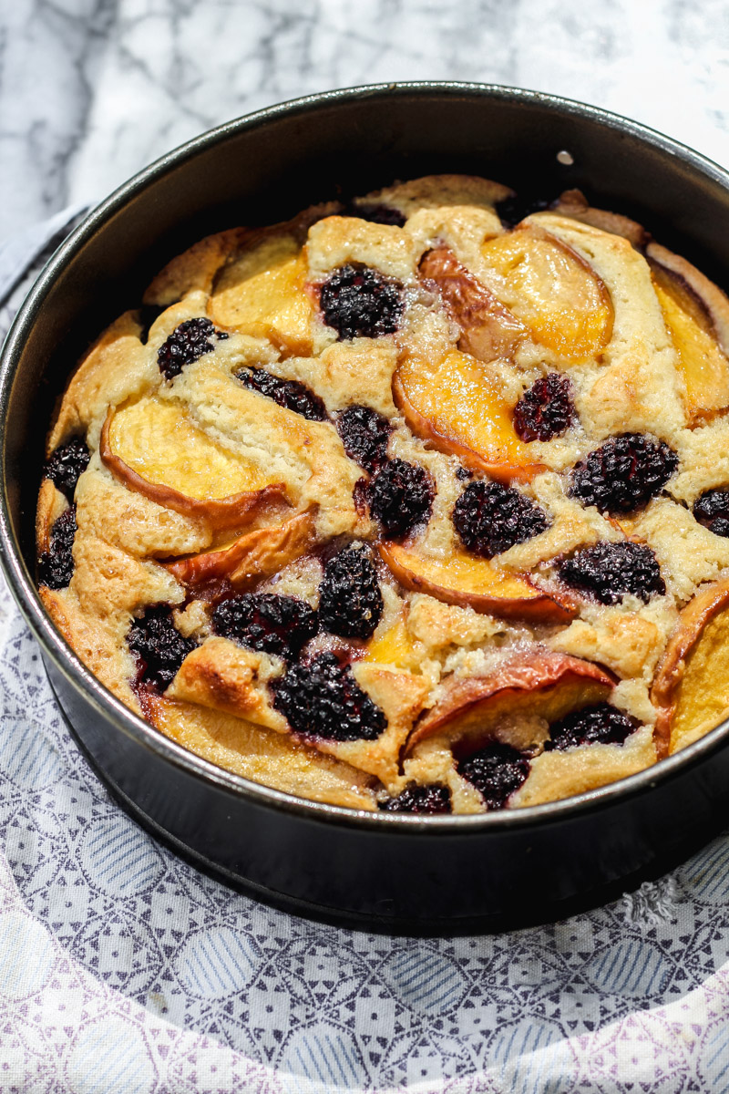 overhead image of gluten-free peach and blackberry cake