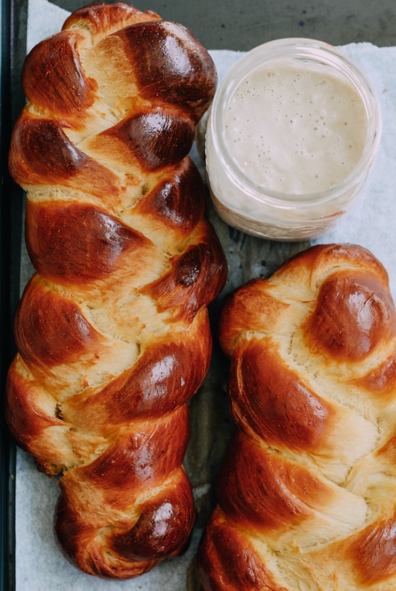 overhead image of sourdough discard challah bread on baking sheet