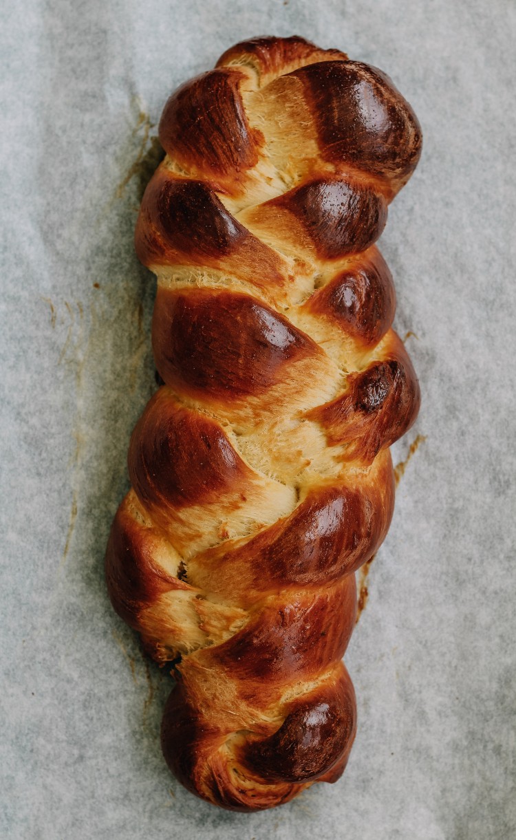 overhead image of challah on parchment paper