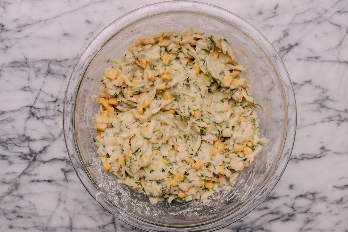 overhead image of making zucchini and corn fritters.