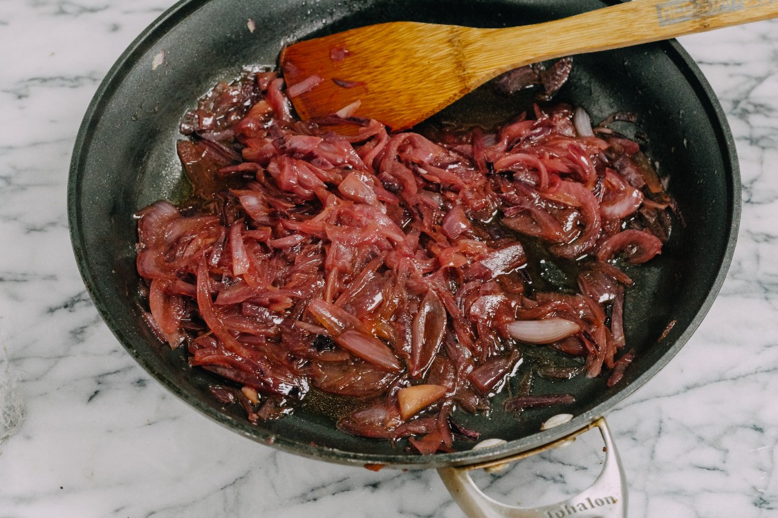 image of caramelizing shallots and onions in a skillet