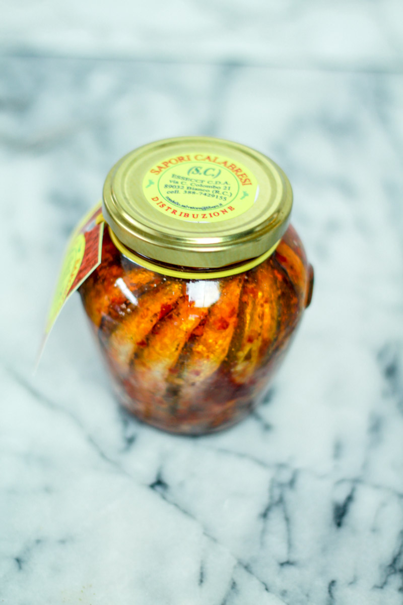 Closeup of anchovies in a jar.