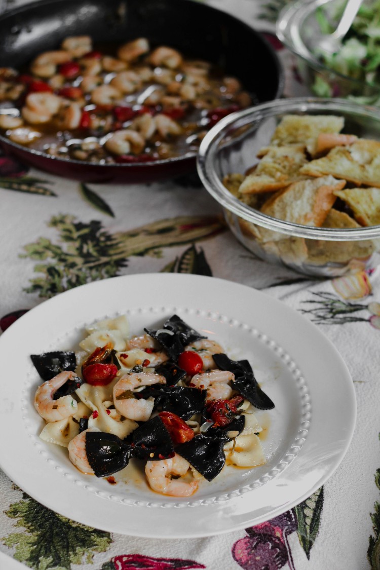 overhead image of pasta with shrimp and cherry tomatoes 