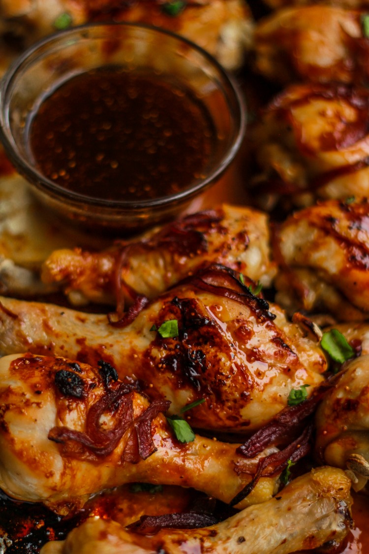 overhead image of chicken with sauce and onions