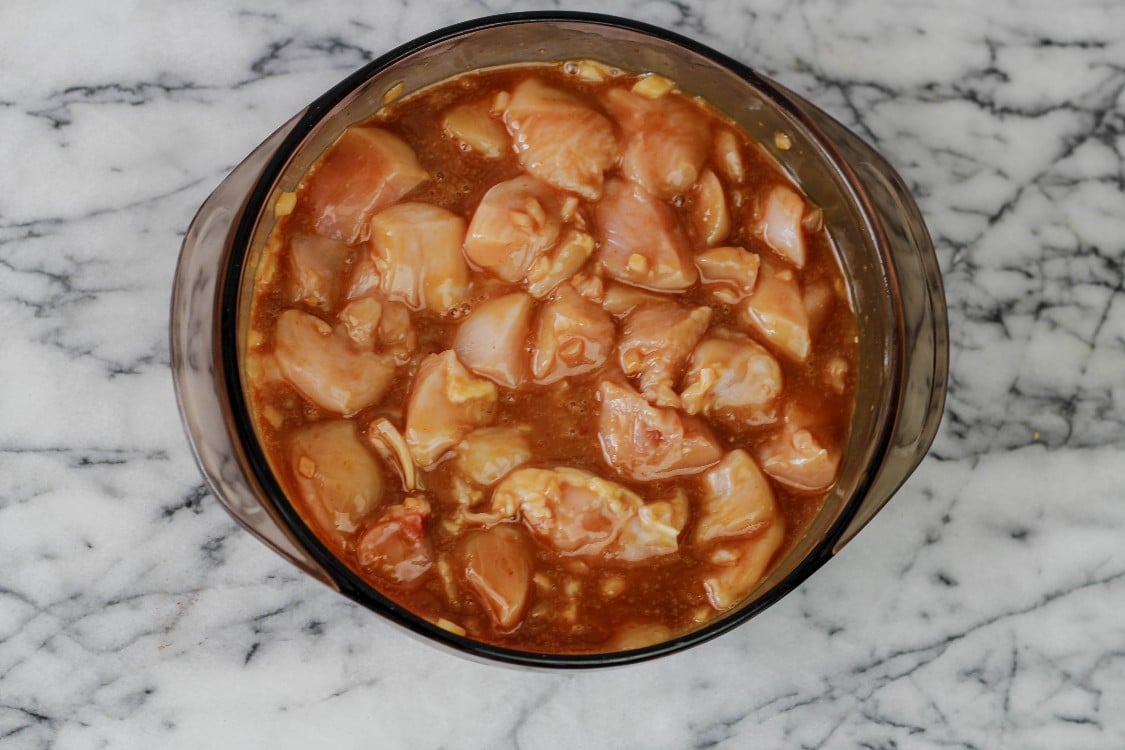 overhead image of prepping sesame chicken in glass bowl 