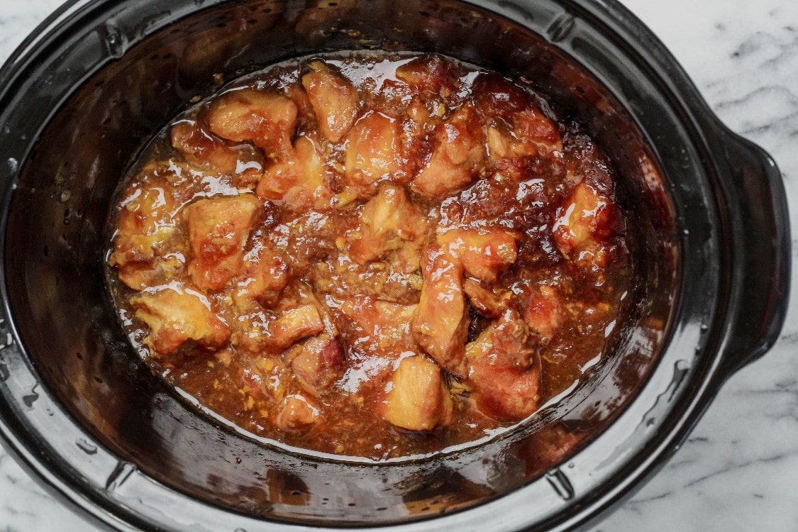overhead image of slow cooker sesame chicken in a crock pot 