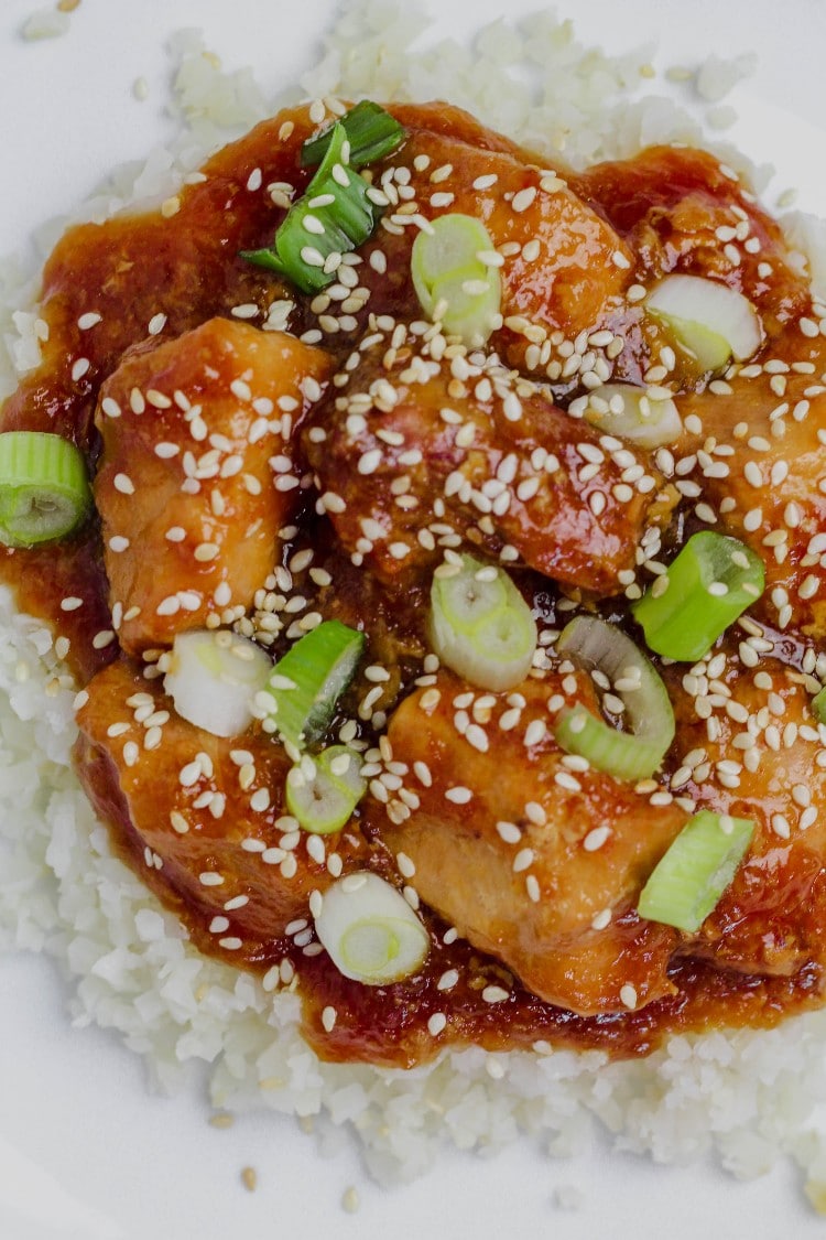 sesame chicken on a white plate 