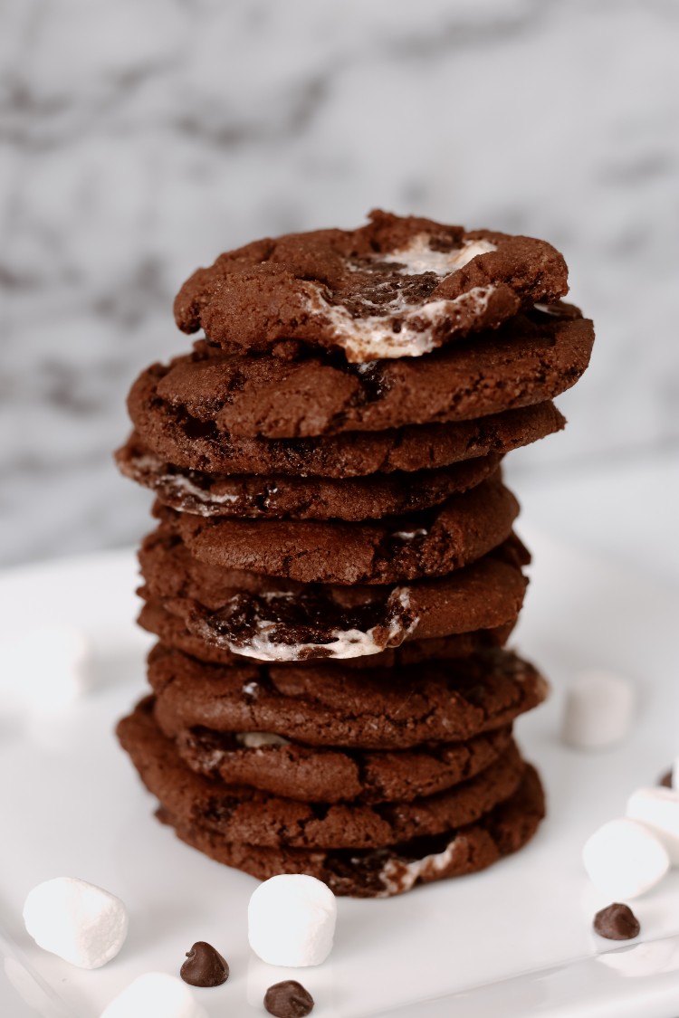 image of stack of vegan hot cocoa cookies and marshmallows on a white dish