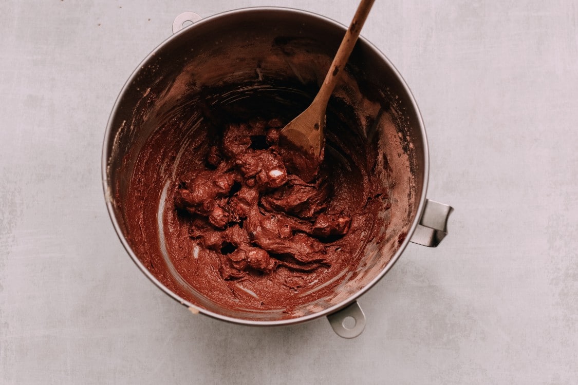 overhead image of making vegan hot cocoa cookies in a metal mixing bowl