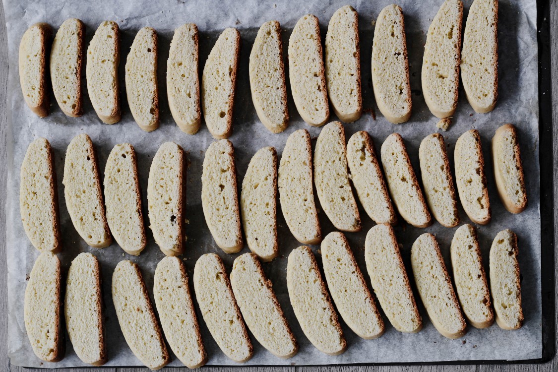 overhead image of biscotti slices on a baking tray 