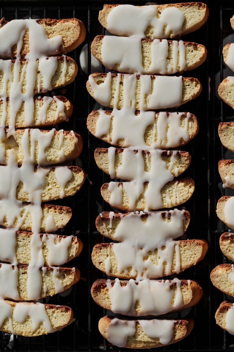 overhead image of lemon biscotti with lemon glaze on a baking sheet