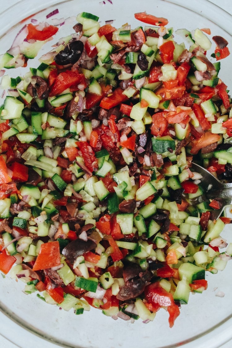 overhead image of chopped salad in a glass bowl
