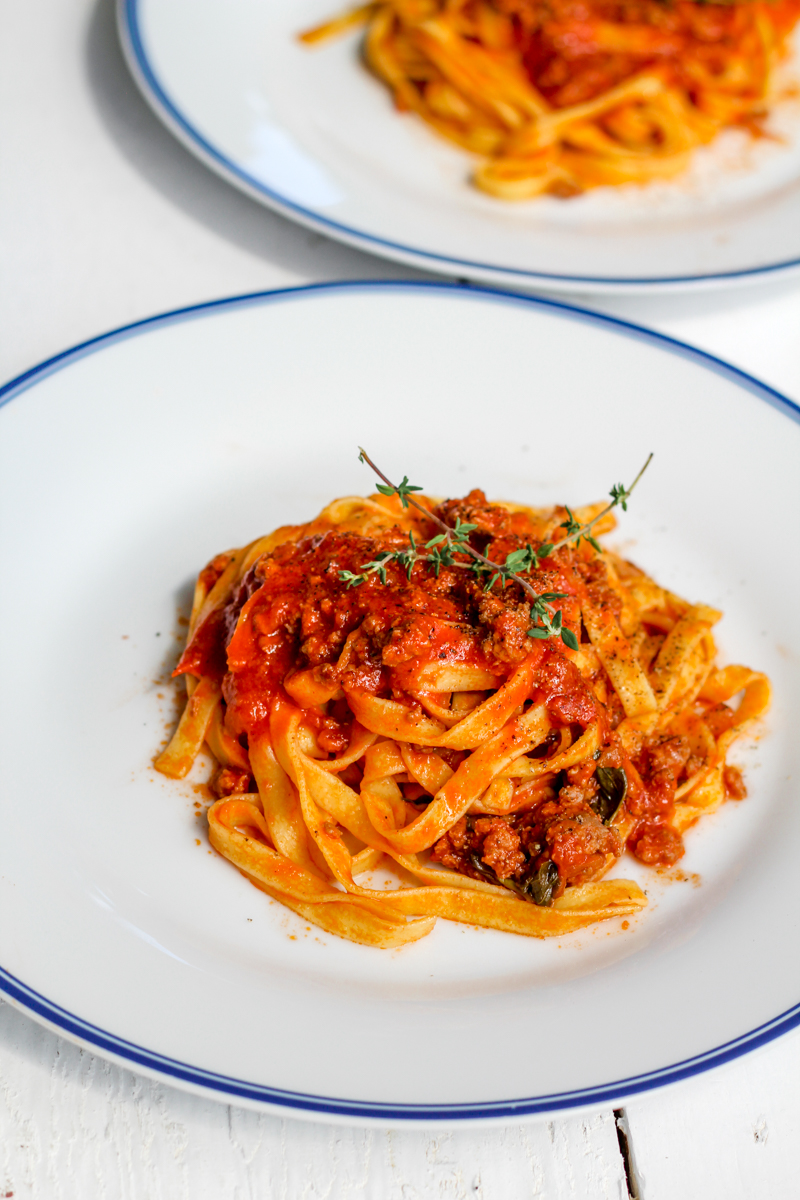 overhead image of fettuccine with weeknight lamb ragu' on a white plate