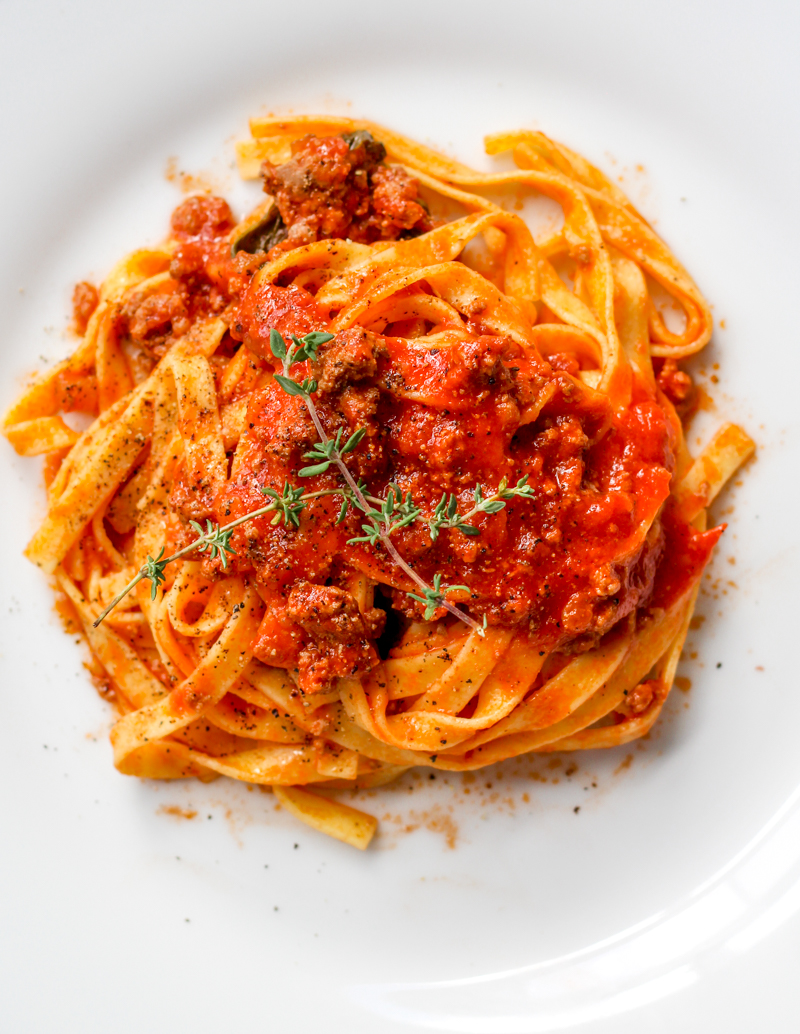 overhead image of fettuccine with weeknight lamb ragu' on a white plate