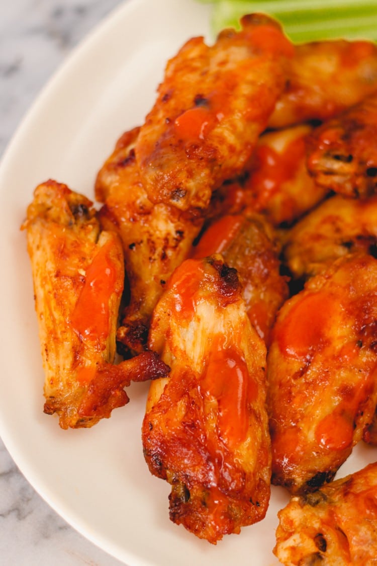 overhead image of chicken wings on a white dish