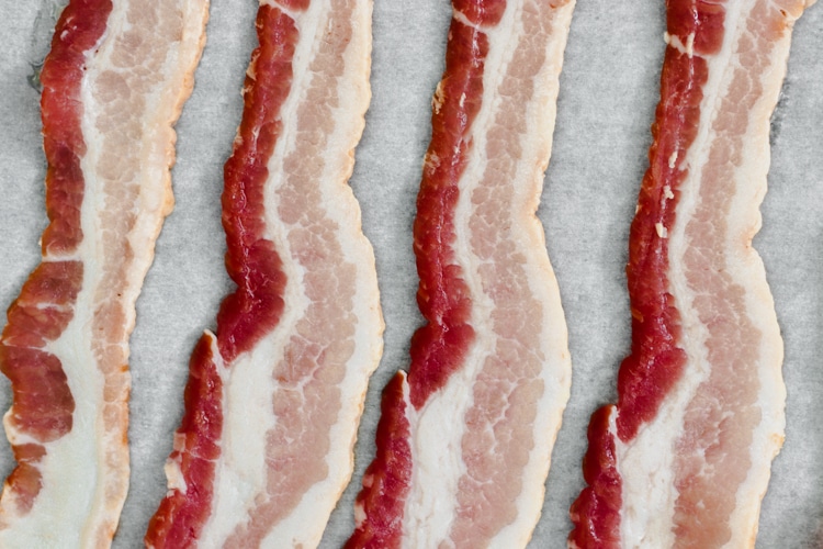 image of bacon on a parchment paper lined tray