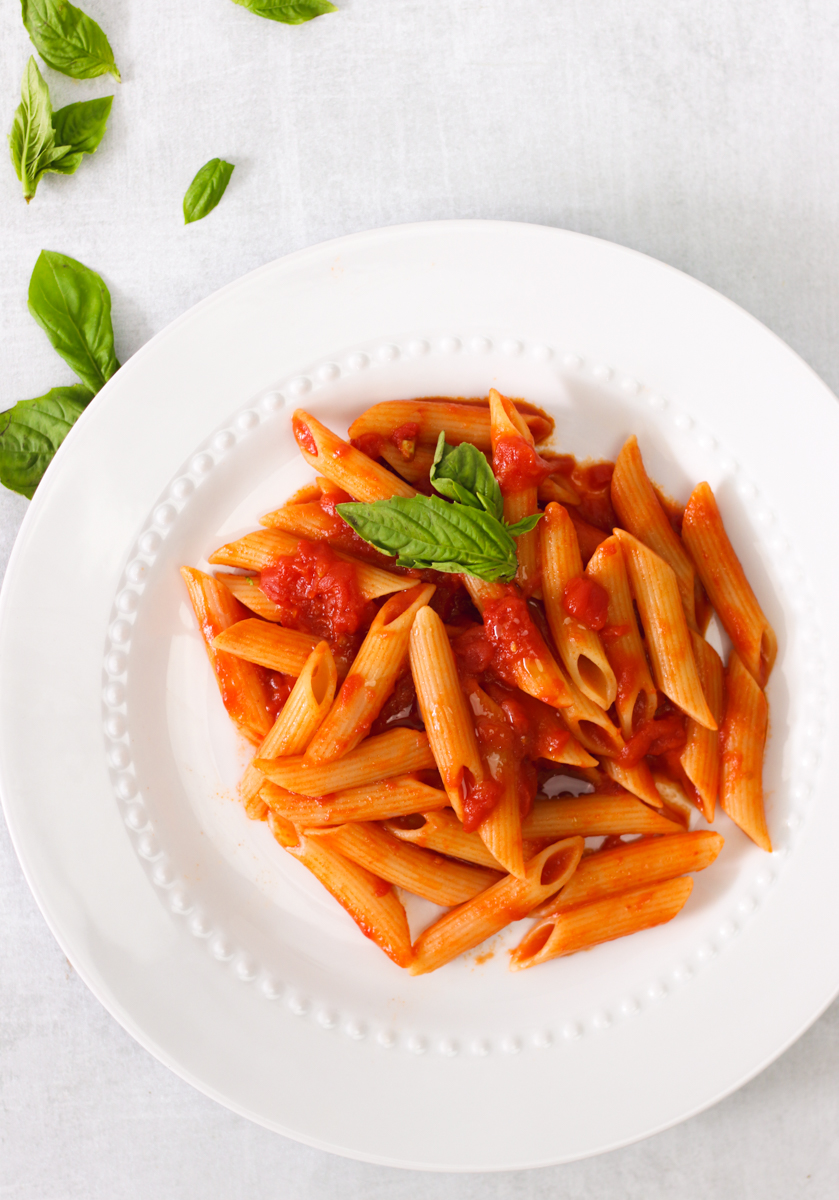 overhead image of easy homemade tomato sauce and pasta on a white plate