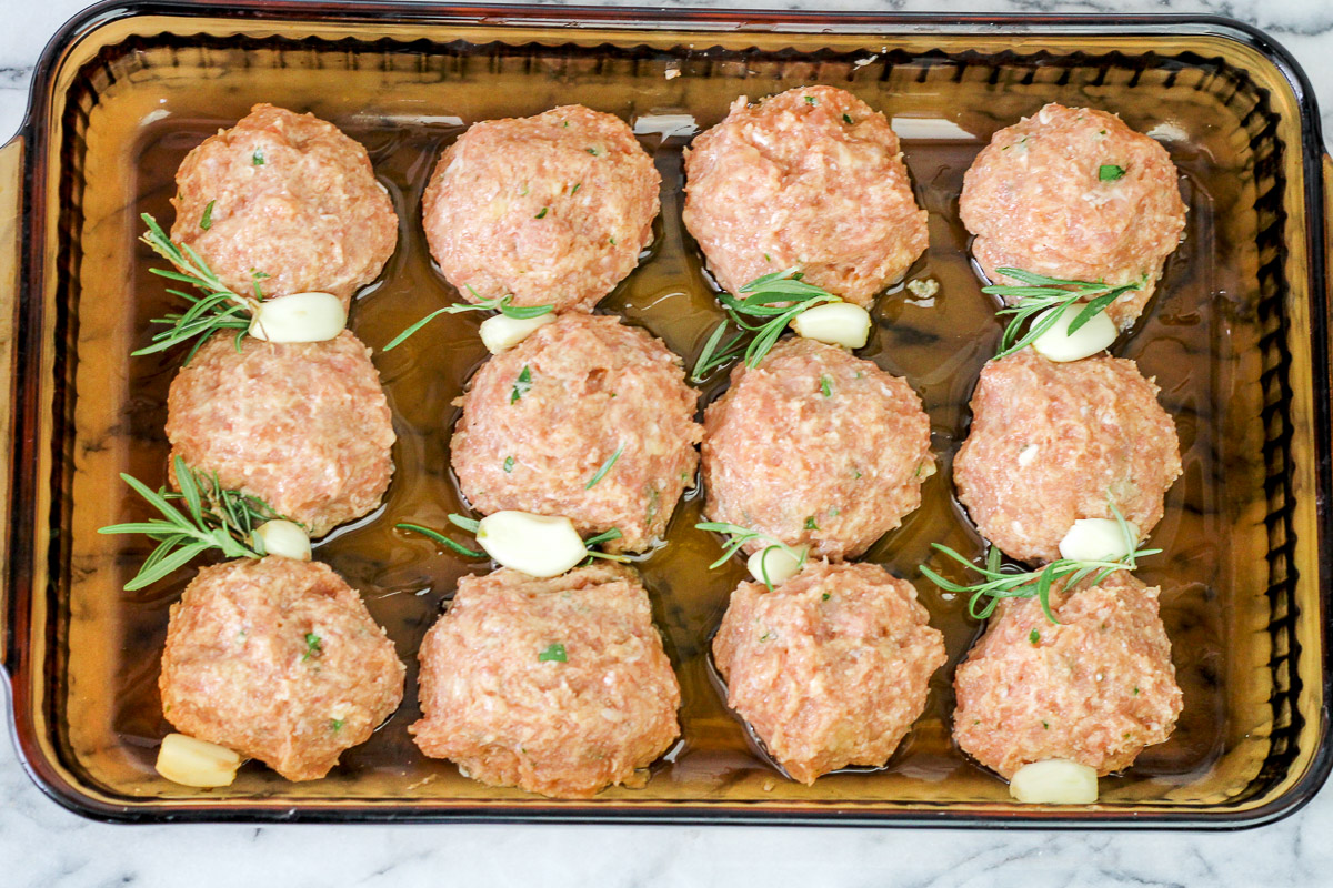 overhead image of meatballs in a brown baking dish