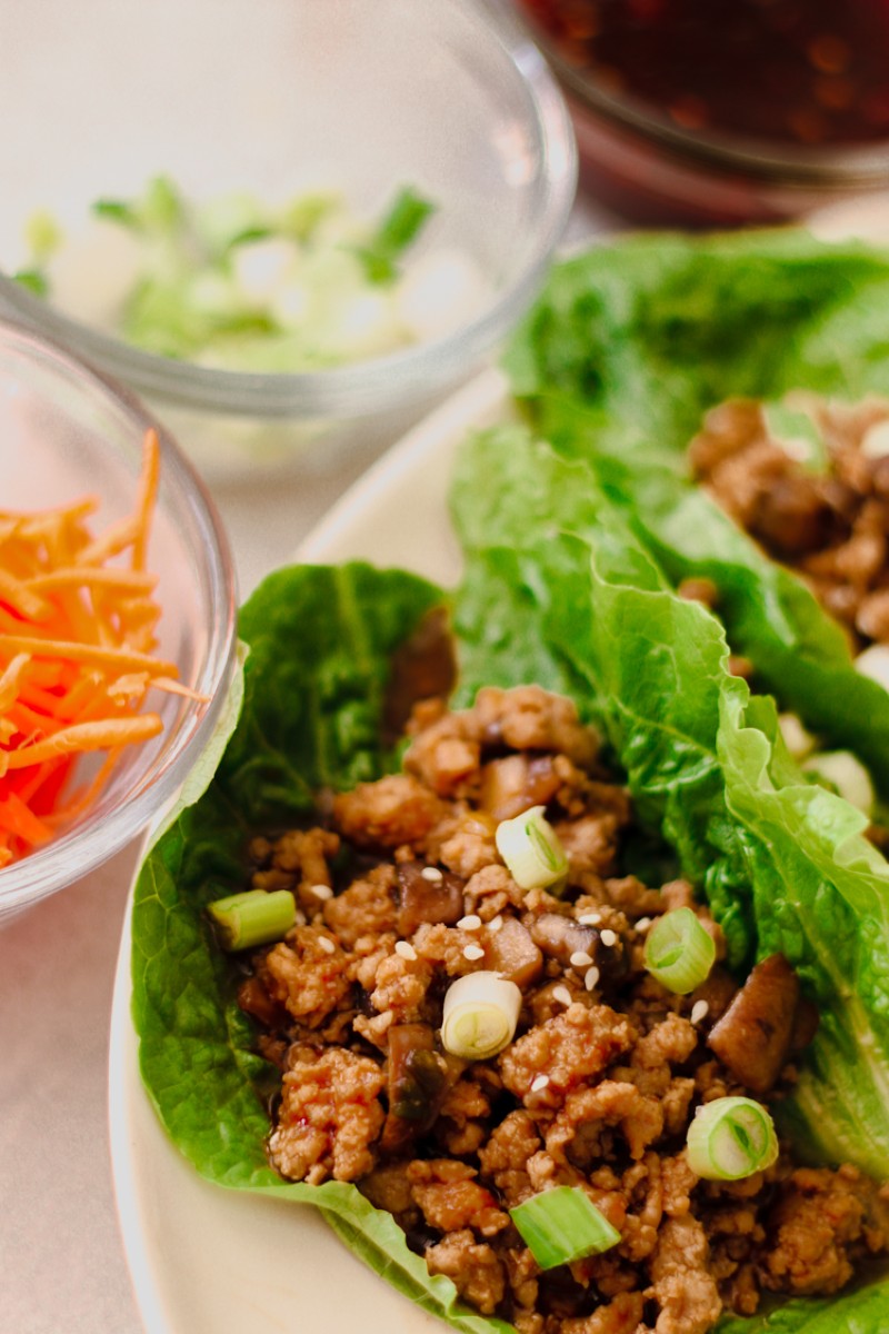 image of chicken lettuce wraps on a white plate