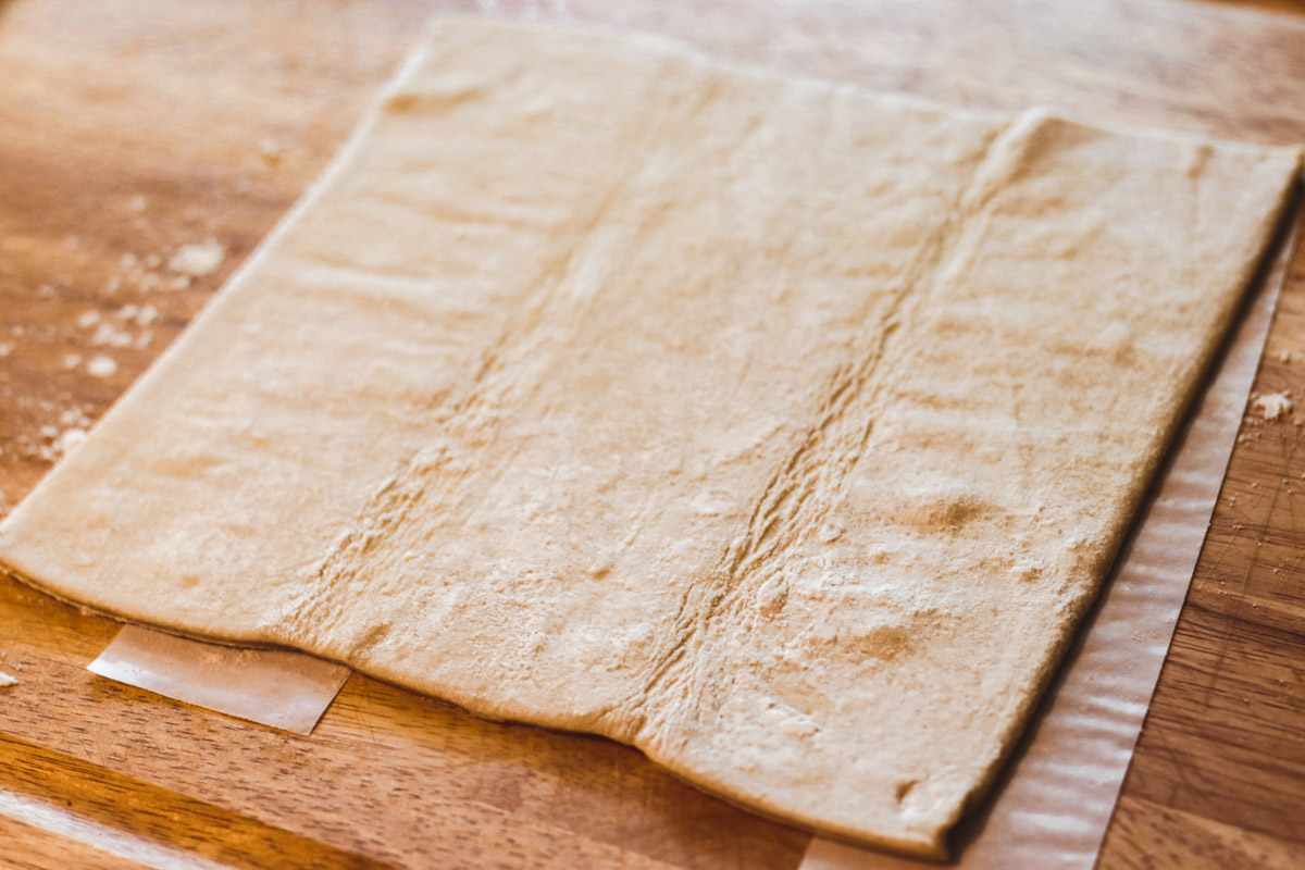overhead image of puff pastry on a cutting board