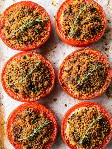 Pomodori gratinati fresh from the oven, cut tomatoes glistening with olive oil and golden breadcrumb crust