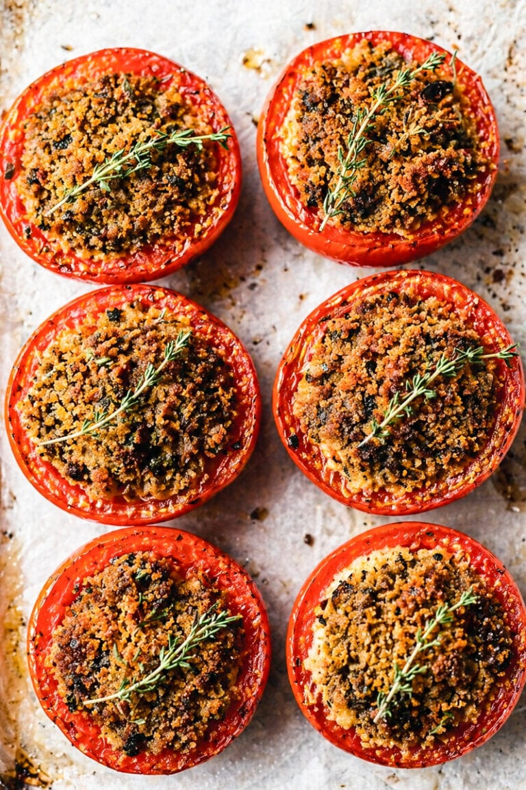 Pomodori gratinati fresh from the oven, cut tomatoes glistening with olive oil and golden breadcrumb crust