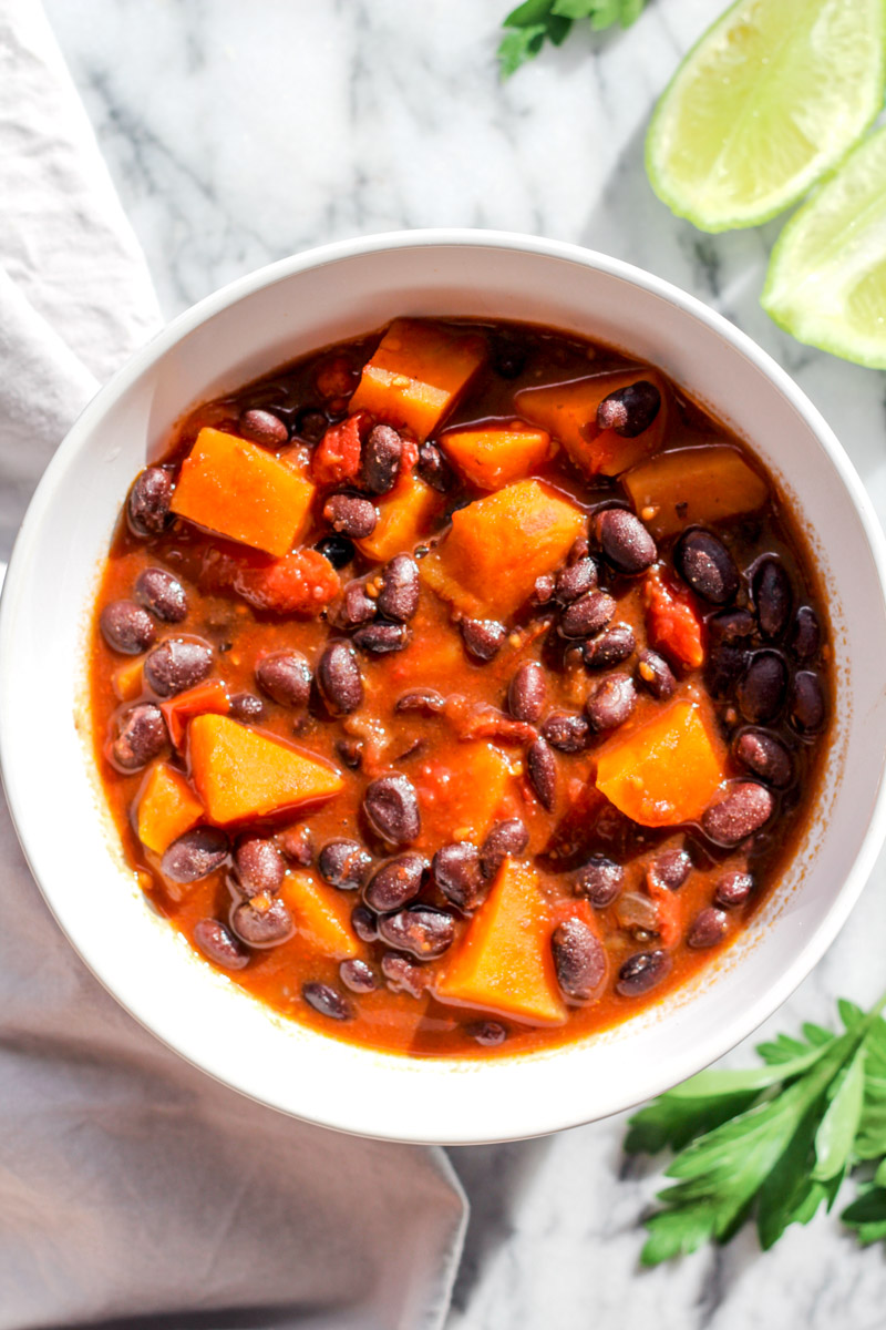 overhead image of sweet potato and black bean chili in a white bowl 