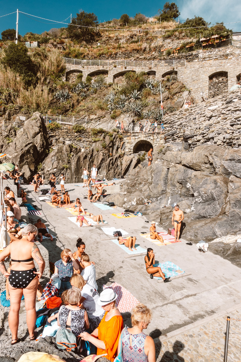 image of people sunbathing in Manarola