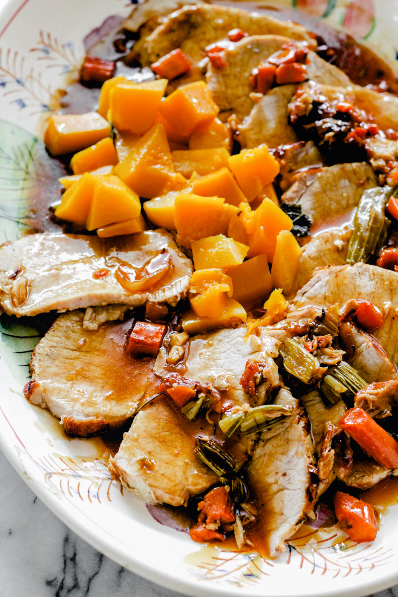 overhead image of roast pork tenderloin with butternut squash in a serving plate