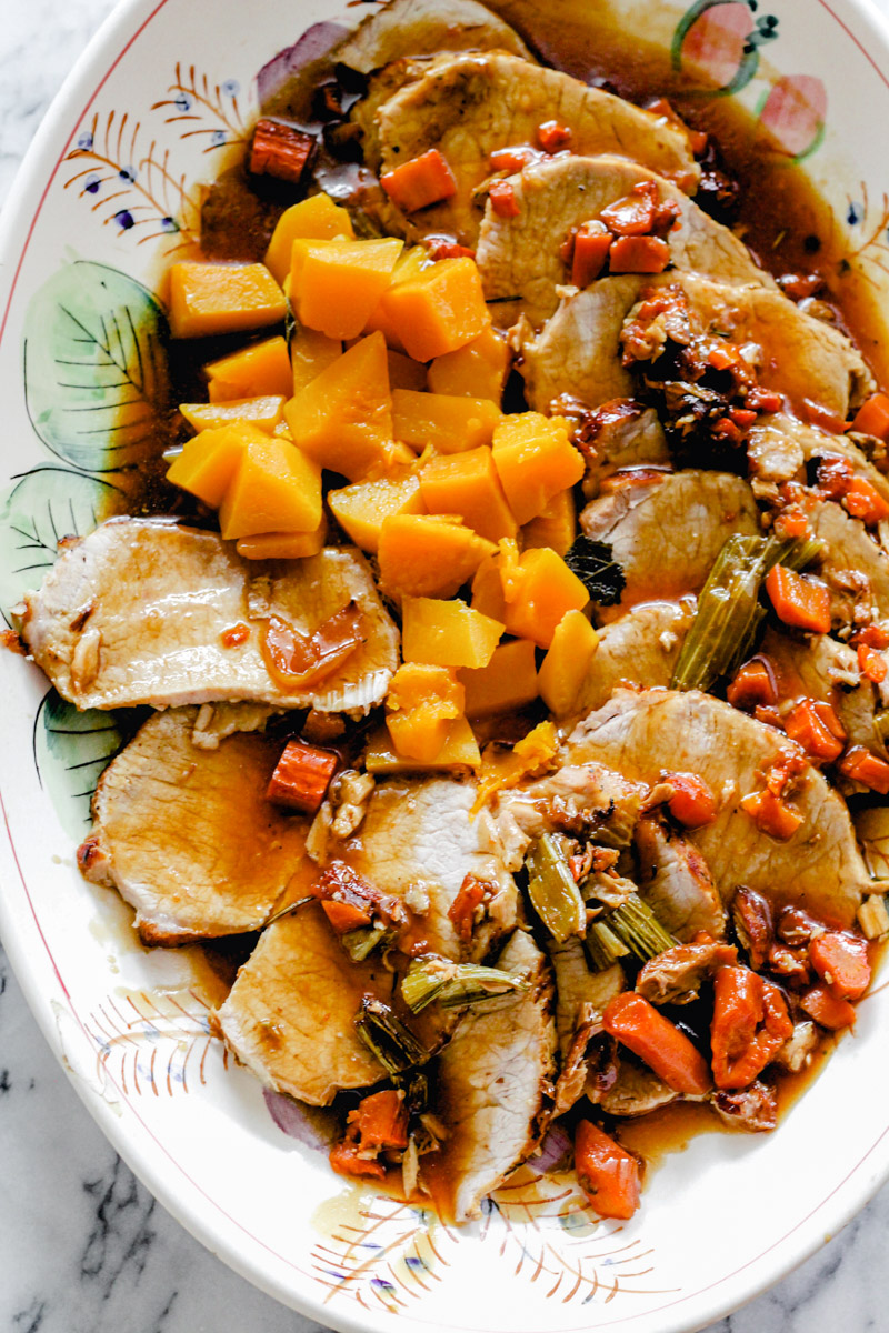 overhead image of roast pork tenderloin with butternut squash in a serving plate