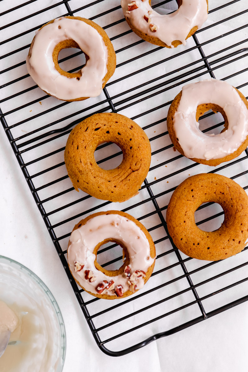 overhead image of easy baked donuts with a maple glaze on a baking rack