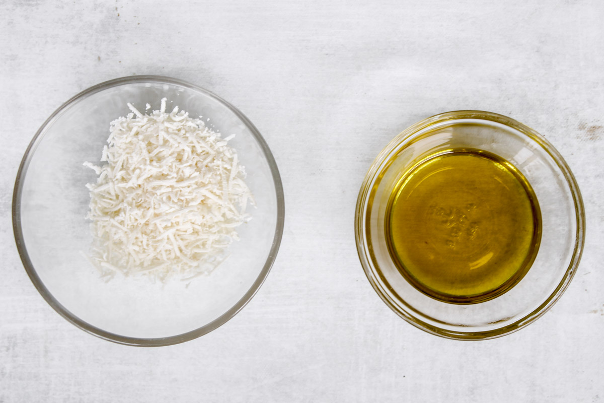 overhead image of cheese and oil in glass bowls