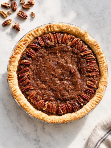 Gluten-free chocolate pecan pie with whole pecans decorating the top